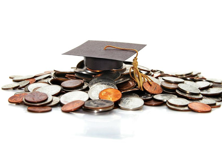 Graduation cap on a pile of money